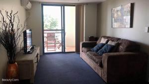 a living room with a couch and a table at Windsurfer Resort in Gold Coast
