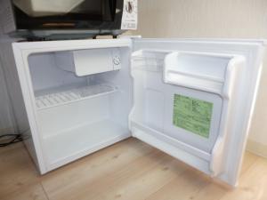 a white refrigerator with its door open in a kitchen at THE MICKEY CARLTON Ohashi 201 in Shiobaru
