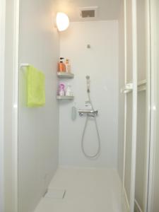 a white bathroom with a shower and a sink at THE MICKEY CARLTON Ohashi 201 in Shiobaru