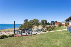 a view of the beach from the backyard of a house at Swansea Motor Inn Tasmania in Swansea