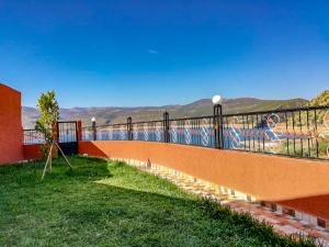 a balcony with a fence and a view of the mountains at superb house in the heart of the mountains in Bine el Ouidane