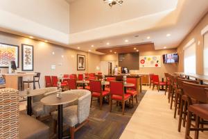 a restaurant with tables and chairs and a bar at  Holiday Inn Express & Suites in Santa Fe