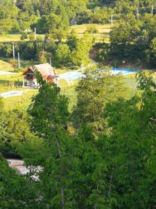 a view of a park with trees and a building at Exo Log Cottage in Jezero