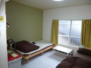 מיטה או מיטות בחדר ב-ザ ミッキー カールトン 井尻 202