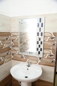 a bathroom with a sink and a mirror at Rathnapala Guest in Badulla