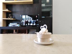 a table with a cup of food on a table at Pretty and independent Apartment located in Tunis city in Tunis