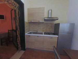 a kitchen with a sink and a refrigerator at Villa Terra Nostra in Vieste