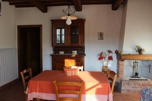 a dining room with a table and a fireplace at Agriturismo La Quercia in Boccheggiano