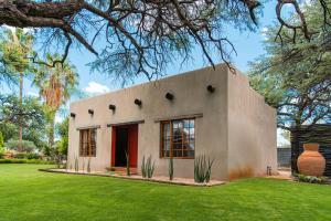 a house with a large yard with a green lawn at Farmstay Okakeua in Okahandja