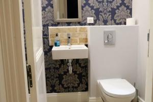 a bathroom with a sink and a toilet at Bordeaux Saint André - elegant, central and quiet in Bordeaux +12 photos