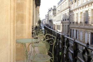 a balcony with tables and chairs on a city street at Bordeaux Saint André - elegant, central and quiet in Bordeaux