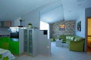 a living room with a couch and a kitchen at Apartments Loncar in Tučepi