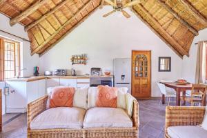 a living room with a couch and a kitchen at 41 Ridge- self catering cottages in Midrand +53 photos