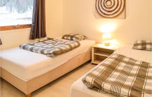 2 łóżka pojedyncze w pokoju z oknem w obiekcie Amazing Home In Nord-statland With 3 Bedrooms And Wifi w mieście Nord-Statland