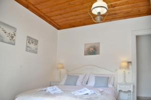 a bedroom with a bed with towels on it at Hydra's Pearl - White Pearl, Luxury Mansion, No steps, 50m from the port in Hydra