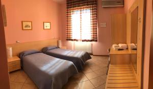 Ένα ή περισσότερα κρεβάτια σε δωμάτιο στο Da Nando Antica Osteria Hotel