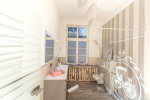 a bathroom with a toilet and a window at Schwarzwaldzimmer & Schwarzwald Design Apartment in Rottweil