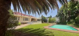 a house with a swimming pool in the yard at The Observatory, Luxury Suite in Observatory Home in Johannesburg