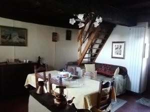 a dining room with a table and a staircase at Gerani Rossi in Civita di Bagnoregio