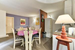 a kitchen and dining room with a pink table and chairs at Accomodation Gina in Zadar