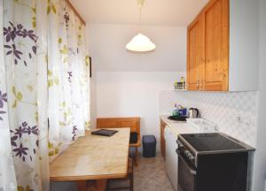 una pequeña cocina con mesa de madera y fregadero en Apartment Kolman, en Bohinj