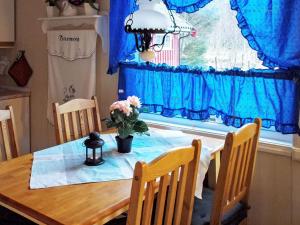 a dining room table with a vase of flowers on it at 6 person holiday home in Vevelstad in Vevelstad