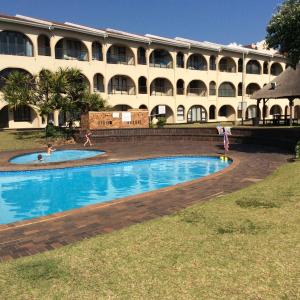 a hotel with two pools in front of a building at Cabanas 21 in Kingsborough
