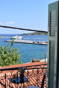 a balcony with a view of a body of water at Pension Ververi in Skiathos