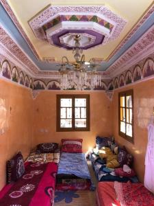 a room with a bunch of beds in it at Dar Imoughlad in Marrakech