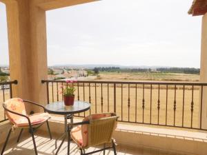 a balcony with a table and two chairs and a window at Excellent 2 bed Apartment in Mandria