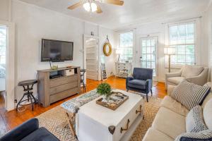 a living room with a couch and a tv at Sea Salt Cottage in Folly Beach