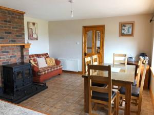 a living room with a table and a fireplace at Atlantic View House in Killybegs