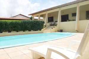 a swimming pool in the backyard of a house at Hotel Pousada Calhau in São Luís