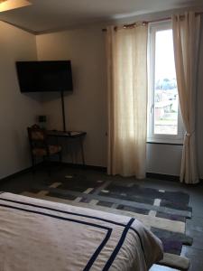 a bedroom with a bed and a large window at L entrepote in Dieppe