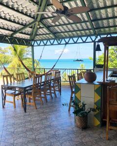a patio with a table and chairs and the ocean at La Terraza Verde in Drake