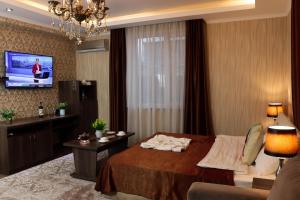 TV a/nebo společenská místnost v ubytování De'Mar Hotel