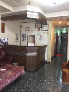 a waiting room with a reception counter in a building at Xiang Dou Hotel in Jiaoxi