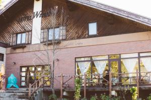 a brick building with windows and a staircase at Hotel Tae Windsor in Myoko
