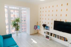 a living room with a flat screen tv on a wall at Skandi apartment near the Park in Irpin
