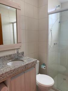 a bathroom with a toilet and a sink and a shower at Apartamento novo Próximo ao Parque Beto carreiro in Penha