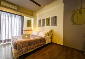 a bedroom with a bed with a laptop on it at Kleopatra Inn in Messini