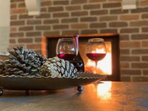 a bowl of pine cones and wine glasses on a table at Beyaz Ev Agva - Adult only +15 in Agva