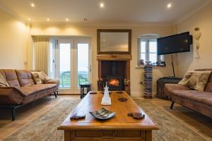 a living room with a couch and a table at The Homestead by Bloom Stays in Canterbury