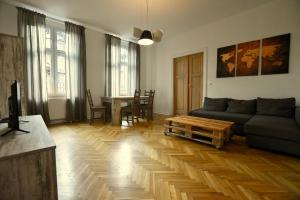 a living room with a couch and a table at Apartament pod Zamkiem 8os. in Bielsko-Biała