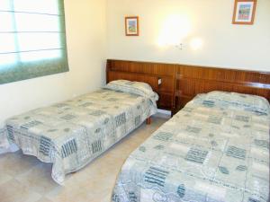 two beds sitting in a room with at TARRACO 20 (BOLLERIA) in L'Estartit