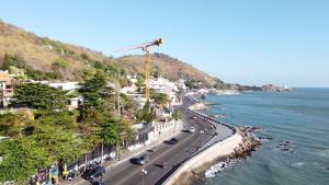 a city with a crane and a road next to the water at Homestay coco in Vung Tau