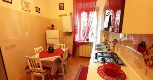 a kitchen with a table and a stove top oven at Casa vacanze bella vista in Bracciano +19 photos