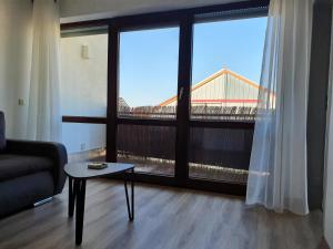 a living room with a couch and a large window at Beautiful City Apartment für bis 4 Personen in Paderborn