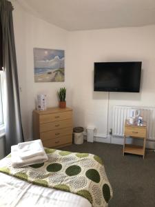 A television and/or entertainment center at Trinity Guest House 