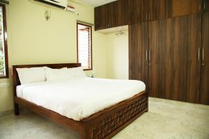 清奈的住宿－Kolam Elliots Beach，一间卧室配有一张大床和木制橱柜。